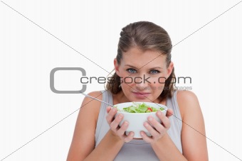 Quiet woman smelling a salad