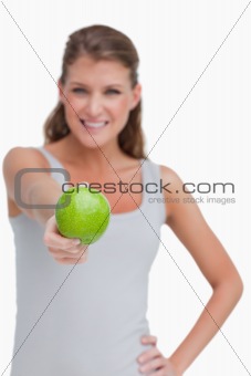 Portrait of a woman giving an apple