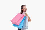 Back view of a cheerful woman holding shopping bags