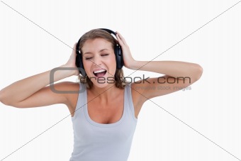Happy woman singing while listening to music