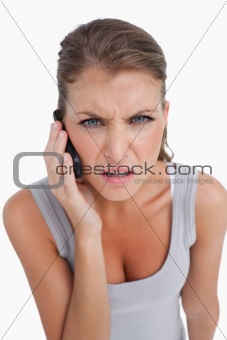 Portrait of a confused woman making a phone call