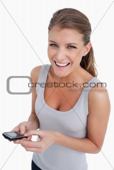 Portrait of a happy woman holding her mobile phone