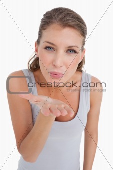 Portrait of a happy woman blowing a kiss