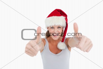 Woman with the thumbs up and a Christmas hat