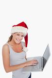Woman with a Christmas hat using a notebook