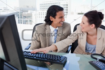 Laughing business team using a computer