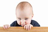 young child holding wooden board