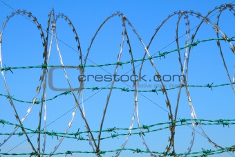 barbed wire against blue sky 