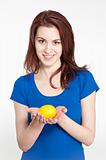 Young woman holding a lemon