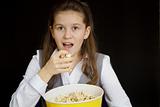 surprised girl with popcorn on a black background