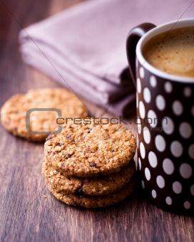 Cinnamon cookies with nuts and mug of delicious coffee