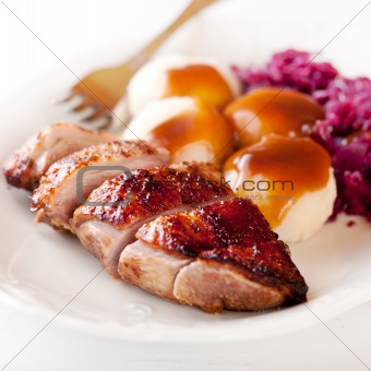 Roast duck breast with potato dumplings and red cabbage