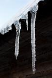 Icicles hang down from a building roof