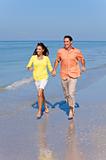 Man & Woman Couple Running on An Empty Beach