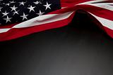 US Flag on dark wooden surface
