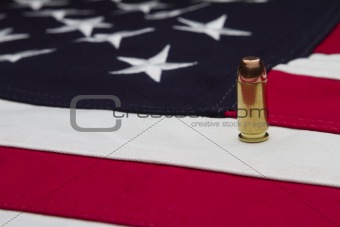 US Flag and a single bullet