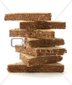 Stack of chocolate filled wafers on white background