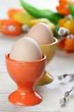 Eggs in orange and yellow eggcups