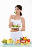 Woman in sportswear eating salad