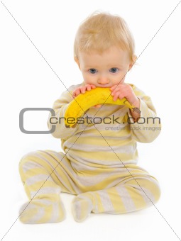 Baby playing with banana isolated on white