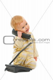 Cute baby speaking on phone isolated on white