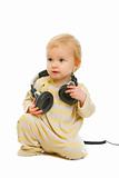 Lovely baby with headphones looking on copyspace isolated on white