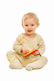 Adorable baby sitting on floor and playing with rattle isolated on white