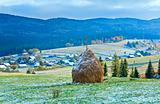 First winter snow and autumn mountain village