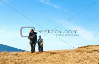 Family walk on autumn  mountain plateau 