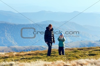 Family make photo on autumn  mountain plateau 