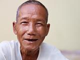 Portrait of happy old asian man smiling at camera