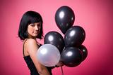 Attractive young girl with birthday balloons