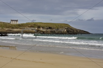 sandy coast with single house in scotland