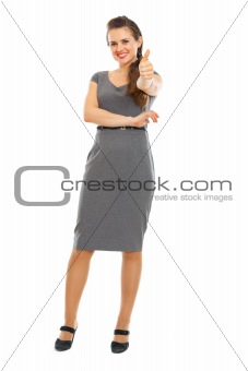 Full length portrait of business woman showing thumbs up