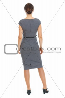 Business woman standing back to camera