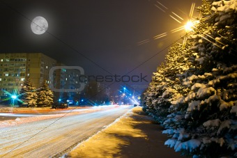 Night snowy road in the small town