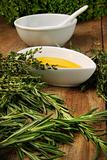 Assorted fresh herbs with olive oil 