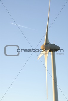 One Wind Turbine and Plane Vapour Trail.