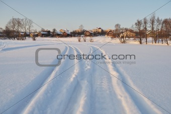Houses next to icy lake, sunset