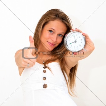 woman holding alarm clock with thumbs up