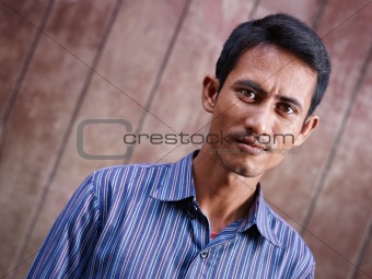 Portrait of mid adult asian man looking at camera