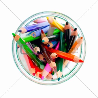 colored pencils in a clear glass jar. top view