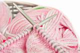 Knitting a pink baby jersey - yarn and needles