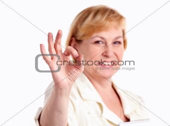 Cheerful mature woman showing the ok sign