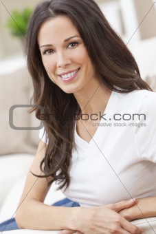 Happy Smiling Beautiful Woman Sitting on Sofa 