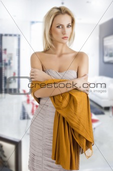 blond girl in elegant dress, her arms are crossed