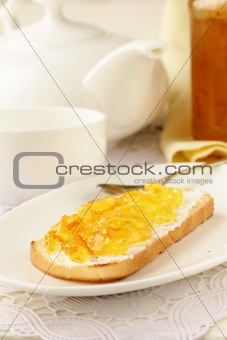 orange jam with toast on plate