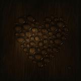 Heart shaped water drops on a wooden texture. 