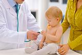 Baby being checked by pediatric doctor using stethoscope