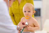 Baby being checked by pediatric doctor using stethoscope